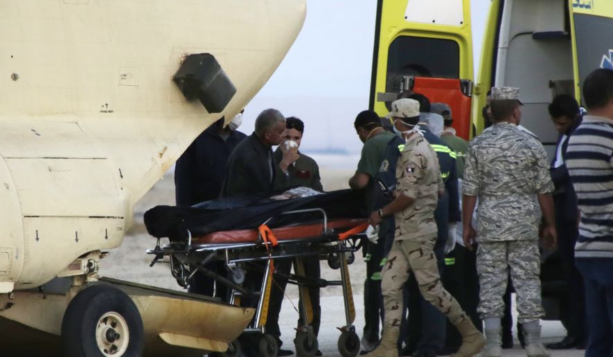 Egyptian emergency workers unload bodies of victims from the crash of a Russian aircraft carrying 217 passengers and 7 crew members over the Sinai peninsula from a police helicopter to ambulances at Kabrit airport in Suez, some 20 miles north of Suez, Egypt, Saturday, Oct. 31, 2015. (AP Photo/Amr Nabil)

