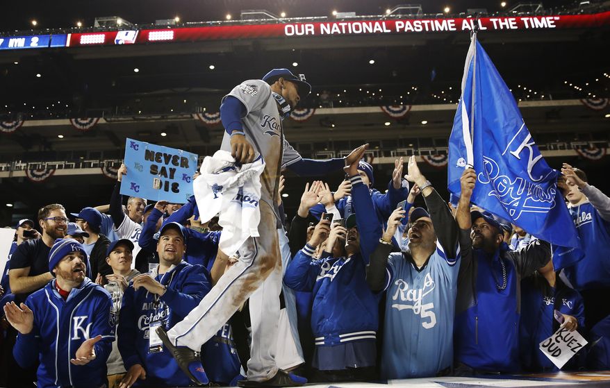 Kansas City Royals' Jarrod Dyson celebrates with fans after Game 5 of the Major League Baseball World Series against the New York Mets Monday, Nov. 2, 2015, in New York. The Royals won 7-2 to win the series. (AP Photo/Matt Slocum)