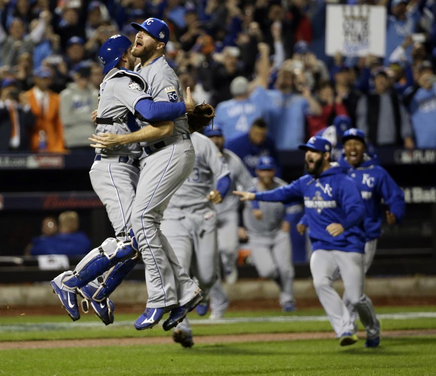 Kansas City Royals catcher Drew Butera and Wade Davis celebrate after Game 5 of the Major League Baseball World Series against the New York Mets Monday, Nov. 2, 2015, in New York. The Royals won 7-2 to win the series. (AP Photo/David J. Phillip)
