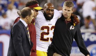 Washington Redskins cornerback DeAngelo Hall (23) is helped off the field during the second half an NFL football game against the New York Giants Thursday, Sept. 24, 2015, in East Rutherford, N.J. (AP Photo/Kathy Willens)