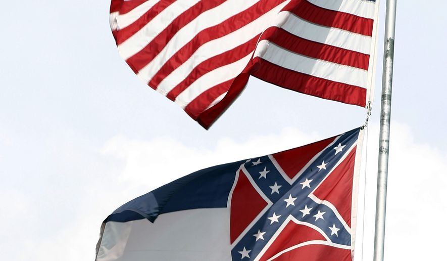 The American and Mississippi state flags fly on a flag pole outside the City Hall in McComb, Miss. (Associated Press)