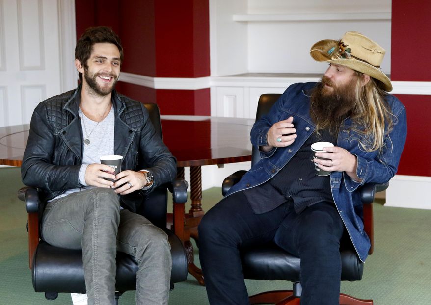 In this Oct. 28, 2015 photo, Thomas Rhett, left, and Chris Stapleton appear in an interview in Nashville, Tenn. Rhett and Stapleton are both nominated for Country Music Association’s new artist award. Rhett, 25, just released his second album, “Tangled Up,” and this is the second time he’s been in the new artist category. Stapleton, 37, has been writing hits for Kenny Chesney, Luke Bryan and George Strait and has had three Grammy nominations as a member of the bluegrass band, the SteelDrivers. The CMA Awards will be held on Wednesday, Nov. 4. (Photo by Donn Jones/Invision/AP)