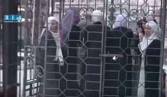 Women loyal to Syrian President Bashar Assad were captured and paraded in cages by the Army of Islam rebel group. (Image: screen grab YouTube)