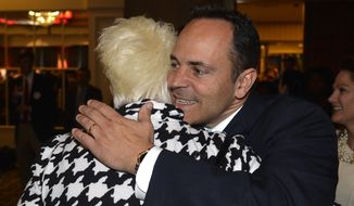 Kentucky Republican gubernatorial candidate Matt Bevin hugs a supporter at the Republican Party celebration Tuesday Louisville, Ky. Mr. Bevin defeated Democrat Jack Conway to become only the second Republican governor in the state in four decades. (Associated Press)