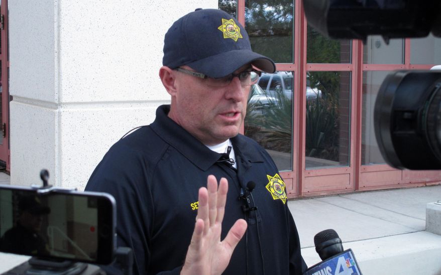 Sparks police detective Sgt. Charles Alt talks to reporters outside police headquarters on Wednesday, Nov. 4, 2015. in Sparks, Nev., after a Washoe County sheriff's deputy critically shot a domestic violence suspect who allegedly drove a pickup truck at the deputy shortly after midnight in Sun Valley. The suspect, Gregory Stewart Kachman, underwent surgery for a single gunshot wound to the chest Wednesday and was reported in critical but stable condition at a Reno hospital. (AP Photo/By Scott Sonner)