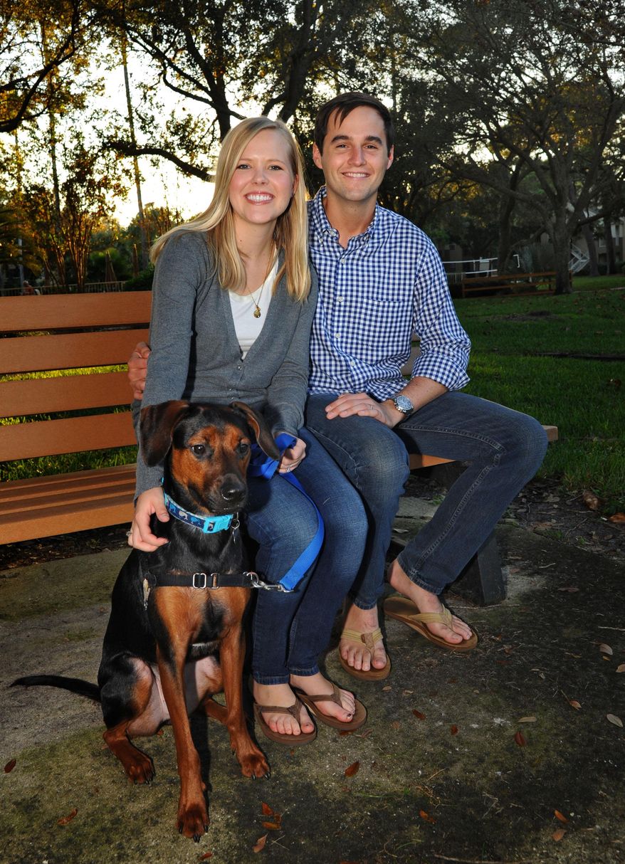 ADVANCE FOR THE WEEKEND OF NOV. 14-15 AND THEREAFTER - In a Thursday Oct. 29, 2015 photo, Todd Blake and his wife Maja pose for a photo with their one-year-old dog Louie near their Ponte Vedra Beach home. Just over a year ago Todd Blake had accepted that he would die from stage IV Hodgkin's lymphoma. Despite the diagnosis he had still gone to college, gotten married, got a puppy, and started a foundation called Live For Today, for young adults with cancer. After trying a new experimental drug he was just diagnosed as being free from cancer. (AP Photo/The Florida Times-Union, Bob Mack)