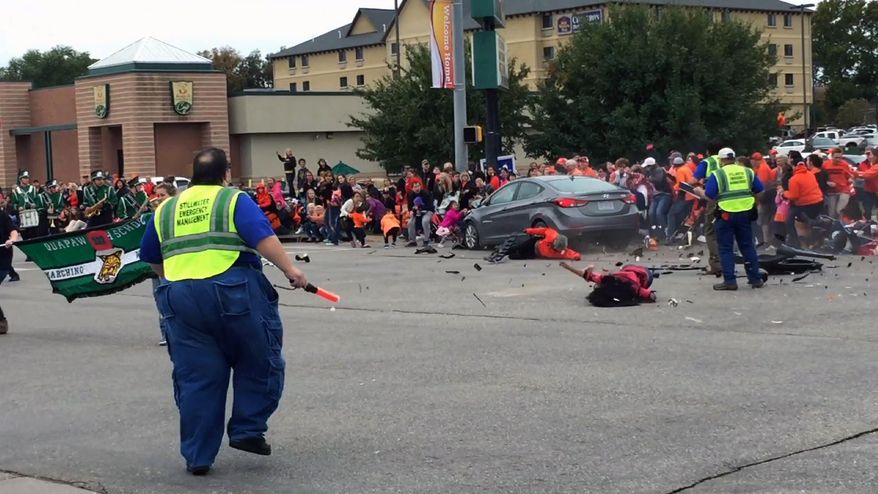 This Oct. 24, 2015, file image taken from video shows the scene in Stillwater, Okla., as a car crashes into spectators at Oklahoma State University's homecoming parade. (Connor J. Greco via AP, File)
