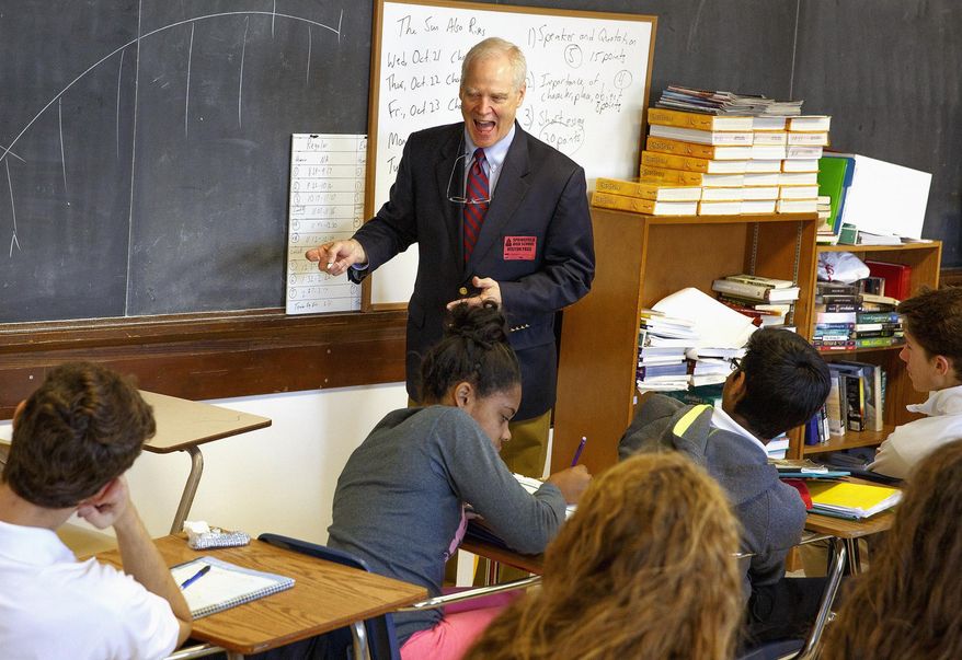 In this Oct. 19, 2015 photo, Andrew Clements, an acclaimed author of children's books, speaks to senior literature students at Springfield High School in Springfield, Ill. Clements is a 1967 graduate of Springfield High School and was inducted as the 53rd member of the school’s Hall of Fame during a school assembly. (Rich Saal/The State Journal-Register via AP) MANDATORY CREDIT, NO SALES