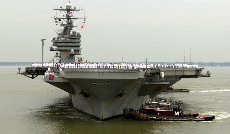 In this May 29, 2003 file photo, sailors man the rails as the USS Theodore Roosevelt is maneuvered into it&#39;s berth at the Norfolk Naval Station in Norfolk, Va. Defense Secretary Carter was flying Thursday onto the USS Theodore Roosevelt, an American aircraft carrier in the disputed waterway. Carter is using the visit to the USS Theodore Roosevelt to amplify the U.S. view that China is making excessive claims that nearly all of the South China Sea as its territory.  (AP Photo/Steve Helber, File)