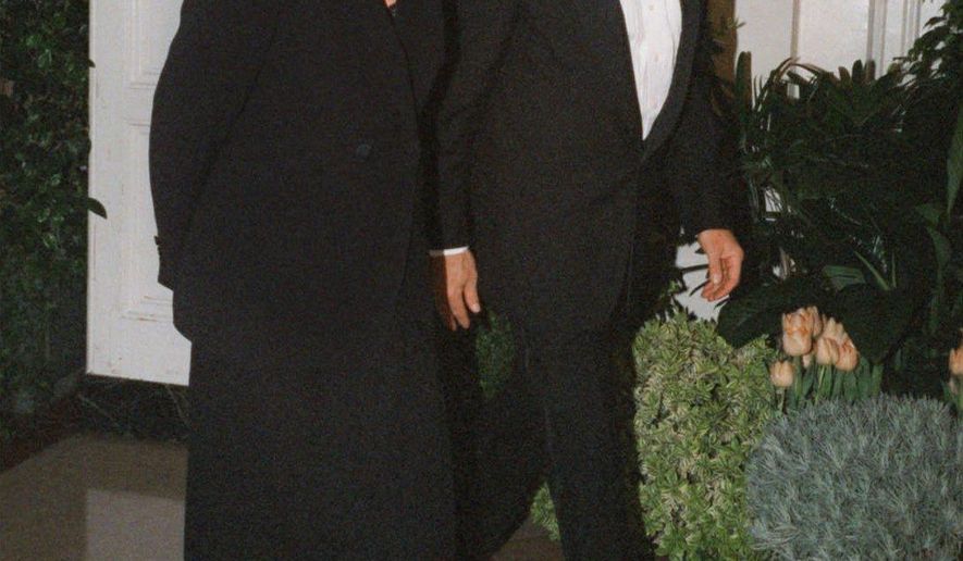 FILE - In this Feb. 5, 1998 file photo, Harrison Ford and his wife Melissa Mathison arrive at the White House for an official dinner for the British Prime Minister hosted by President Clinton in Washington. Mathison, the screenwriter who crafted the enchanting worlds of iconic family films including "E.T. the Extra Terrestrial," has died. She passed away Wednesday, Nov. 4, 2015, at age 65 after a bout with neuroendocrine cancer, her sister, Melinda Mathison Johnson, confirmed. Mathison was married to Harrison Ford for 21 years and divorced in 2004. (AP Photo/Neshan H. Naltchayan, File)