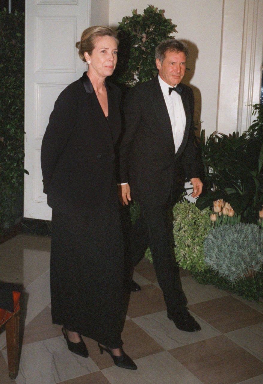 FILE - In this Feb. 5, 1998 file photo, Harrison Ford and his wife Melissa Mathison arrive at the White House for an official dinner for the British Prime Minister hosted by President Clinton in Washington. Mathison, the screenwriter who crafted the enchanting worlds of iconic family films including "E.T. the Extra Terrestrial," has died. She passed away Wednesday, Nov. 4, 2015, at age 65 after a bout with neuroendocrine cancer, her sister, Melinda Mathison Johnson, confirmed. Mathison was married to Harrison Ford for 21 years and divorced in 2004. (AP Photo/Neshan H. Naltchayan, File)