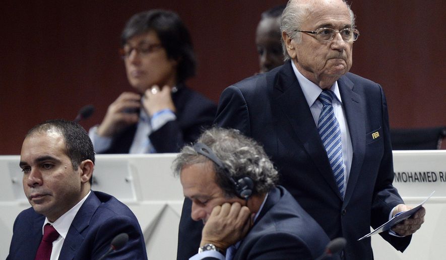 FILE - In this May 29, 2015 file photo FIFA president Joseph S. Blatter, right, walks past Prince Ali bin al-Hussein, left, and UEFA President Michel Platini, center, during the 65th FIFA Congress held at the Hallenstadion in Zurich, Switzerland. In a FIFA election that is now more open than expected, Prince Ali bin al-Hussein has had to change strategy since Michel Platini was caught up in a corruption allegation, it was reported on Thursday, Nov. 5, 2015. Prince Ali struck a more cautious note in an interview with the Associated Press than the fighting talk he directed at Platini before the one-time election favorite was quizzed in a Swiss criminal investigation of a $2 million payment from FIFA in 2011. (Walter Bieri/Keystone via AP, File)