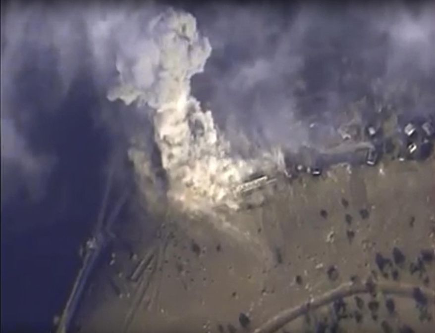 This photo made from the footage taken from Russian Defense Ministry official web site on Monday, Nov. 2, 2015 shows a target hit during s Russian air raid in Syria. Russian Defense Ministry said the strike was performed by an Su-34M bomber in Aleppo province. (AP Photo/ Russian Defense Ministry Press Service)
