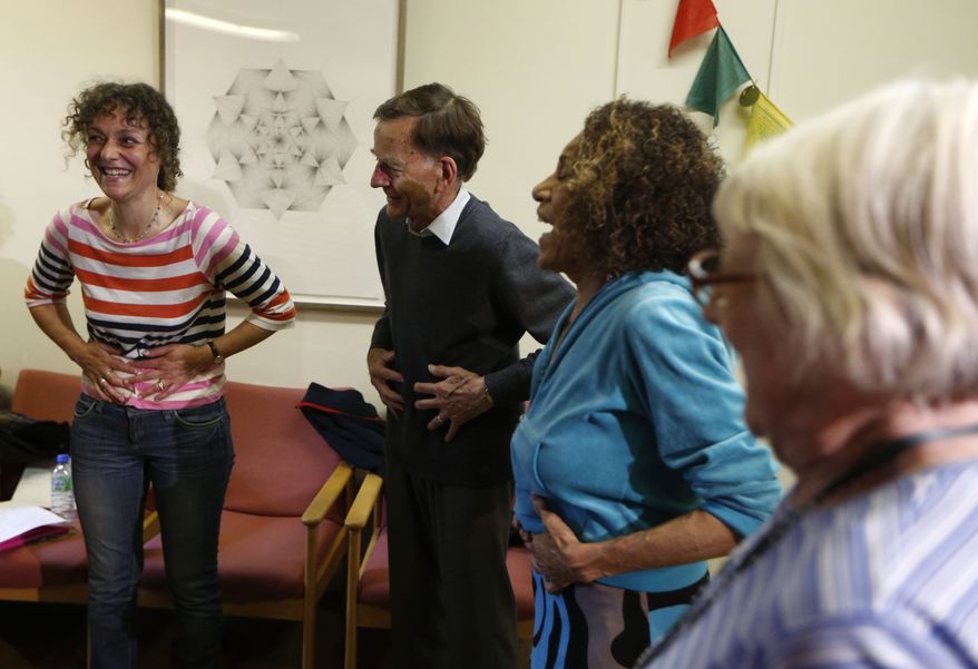 Joanna Foster, actress, singer and singing teacher, left, leads a singing class at Royal Brompton Hospital in London, Monday, June 17, 2013. The weekly group is led by a professional musician and is offered to people with respiratory problems including asthma, emphysema and Chronic Obstructive Pulmonary Disorder, or COPD. Doctors at London's Royal Brompton Hospital started the program after reasoning that the kind of breathing used by singers might also help lung patients. (AP Photo/Sang Tan)