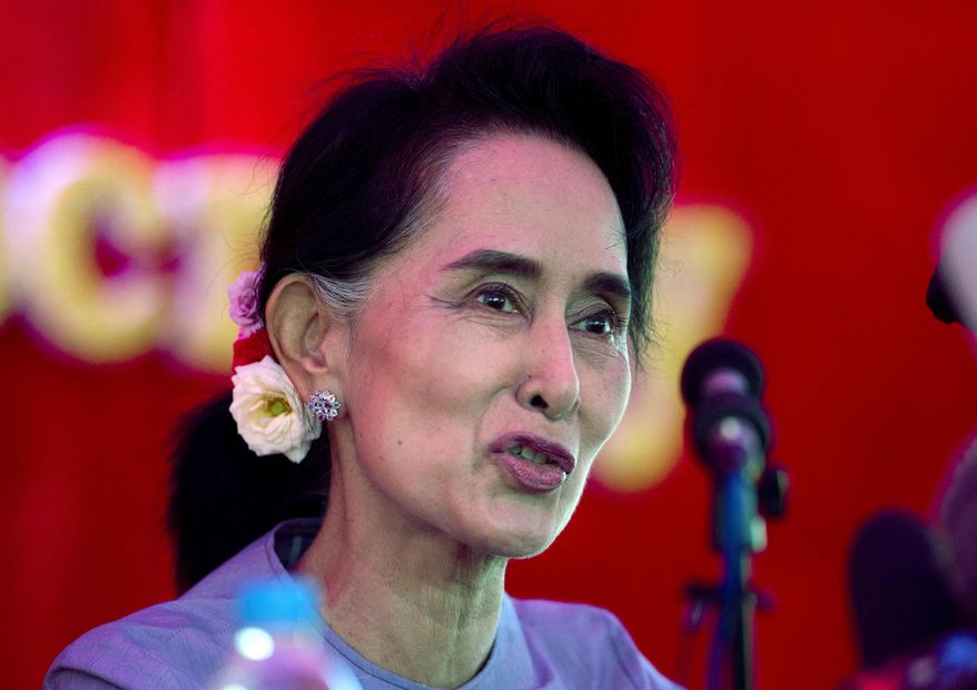 Myanmar's opposition leader Aung San Suu Kyi addresses the media at a press conference at her home in Yangon, Myanmar, Thursday, Nov. 5, 2015. On Sunday Myanmar will hold what is being viewed as the country's best chance for a free and credible election in a quarter of a century.(AP Photo/Mark Baker)