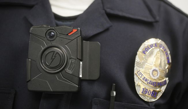 A Los Angeles Police officer wears an on-body camera during a demonstration in Los Angeles on Jan. 15, 2014. (Associated Press) **FILE**