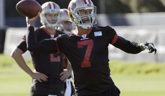 San Francisco 49ers quarterback Blaine Gabbert, rear, watches as quarterback Colin Kaepernick (7) passes during an NFL football practice in Santa Clara, Calif., Wednesday, Nov. 4, 2015. Head coach Jim Tomsula announced that the 49ers have officially made the change at quarterback from Kaepernick to Gabbert. (AP Photo/Jeff Chiu)