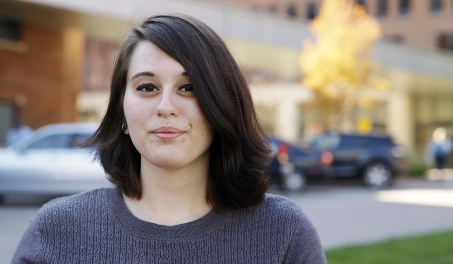 In this Wednesday, Nov. 4, 2015, photo, Miranda Taylor poses for a photo outside Christ College of Nursing and Health Science in Cincinnati. Taylor, a student at the college, was part of a study of teen obesity surgery at the Children's Hospital Medical Center. (AP Photo/Michael Conroy)