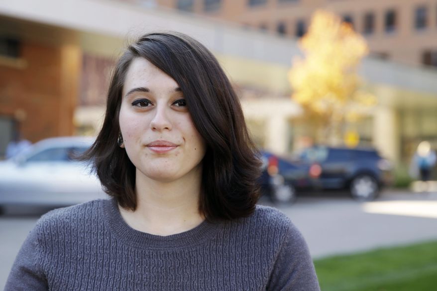 In this Wednesday, Nov. 4, 2015, photo, Miranda Taylor poses for a photo outside Christ College of Nursing and Health Science in Cincinnati. Taylor, a student at the college, was part of a study of teen obesity surgery at the Children's Hospital Medical Center. (AP Photo/Michael Conroy)