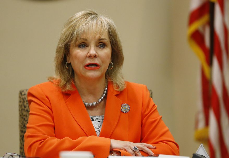 In this Tuesday, Aug. 4, 2015 file photo, Oklahoma Gov. Mary Fallin talks with the media in Oklahoma City. Oklahoma prisons director Robert Patton’s tenure at the Department of Corrections has been marred by problems with three scheduled executions and now a multi county grand jury into those complications. Fallin has said she wants to wait and see what’s uncovered by Attorney General Scott Pruitt’s investigation before publicly endorsing Patton. (AP Photo/Sue Ogrocki, File)
