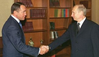 Russian President Vladimir Putin (right) with Mikhail Lesin in 2002. (Image: ITAR-TASS)
