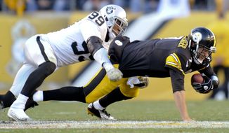 Pittsburgh Steelers quarterback Ben Roethlisberger (7) is injured as he is tackled by Oakland Raiders outside linebacker Aldon Smith (99) in the fourth quarter of an NFL football game Sunday, Nov. 8, 2015, in Pittsburgh. The Steelers won 38-35. (AP Photo/Don Wright)