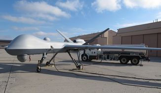 In this Nov. 3, 2015, photo, a Predator drone owned by the U.S. Customs and Border Protection sits on the tarmac awaiting takeoff from the agency&#39;s Grand Forks Air Force Base operations in North Dakota. The unmanned aircraft is about the size of a business jet and can fly for at least 20 hours, but experienced pilots say it&#39;s a difficult plane to land. (AP Photos/Dave Kolpack) ** FILE **