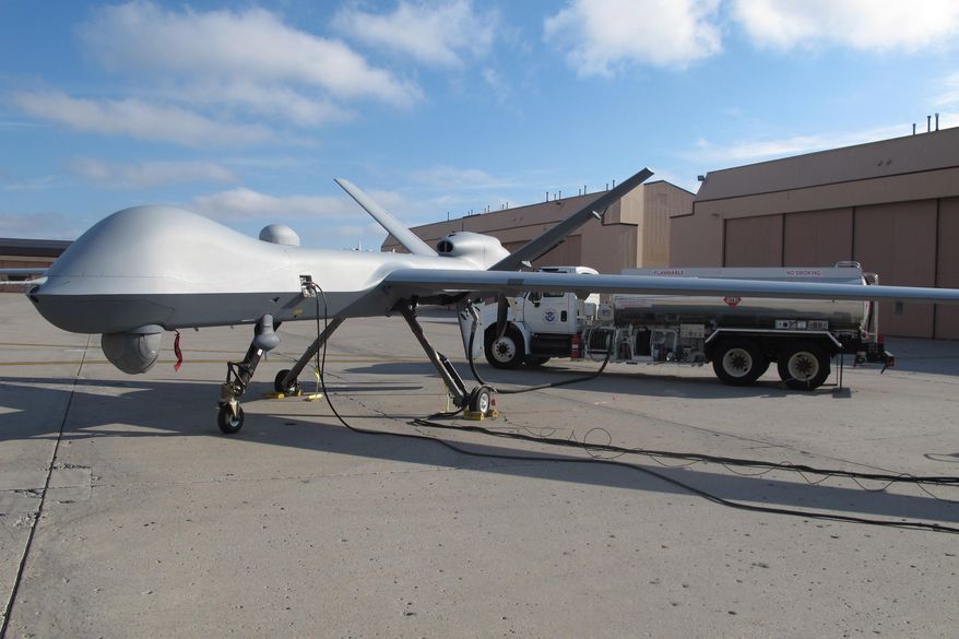 In this Nov. 3, 2015, photo, a Predator drone owned by the U.S. Customs and Border Protection sits on the tarmac awaiting takeoff from the agency&#39;s Grand Forks Air Force Base operations in North Dakota. The unmanned aircraft is about the size of a business jet and can fly for at least 20 hours, but experienced pilots say it&#39;s a difficult plane to land. (AP Photos/Dave Kolpack) ** FILE **