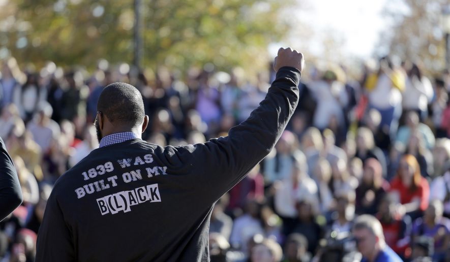 In this file photo, a member of the black student protest group Concerned Student 1950 gestures while addressing a crowd following the announcement that University of Missouri System President Tim Wolfe would resign Monday, Nov. 9, 2015, at the university in Columbia, Mo. Wolfe resigned Monday with the football team and others on campus in open revolt over his handling of racial tensions at the school. (AP Photo/Jeff Roberson) **FILE**