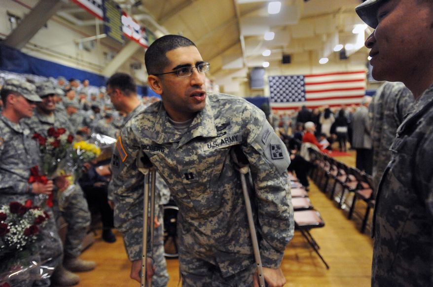 Capt. Florent Groberg returns for the Change of Command ceremony for the 4th Infantry Brigade Combat Team, at Fort Carson's Special Events Center, in Colo., in this Feb. 14, 2013, file photo. On Thursday, Nov. 12, 2015, President Obama will present him with the Medal of Honor, which will make Groberg the 10th living recipient of the nation’s highest military award for actions in Afghanistan. (Christian Murdock/The Gazette via AP, File)