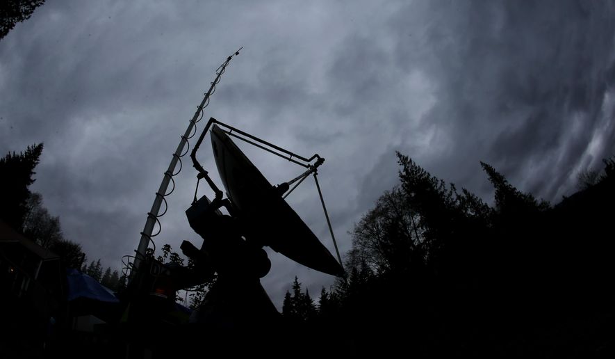 A truck-mounted radar instrument called the Doppler On Wheels is silhouetted against cloudy skies Friday, Nov. 6, 2015, on the banks of Lake Quinault near Amanda Park, Wash. Led by NASA and hosted by the University of Washington, a team of meteorologists and scientists is fanning out across one of the wettest places in the country in November to measure raindrops and snowdrops and attempt to validate, on the ground, how well global satellites measure precipitation from space. (AP Photo/Ted S. Warren) ** FILE **