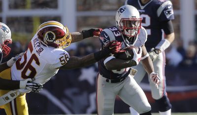 New England Patriots running back Dion Lewis (33) runs from Washington Redskins linebacker Perry Riley (56) during the first half of an NFL football game, Sunday, Nov. 8, 2015, in Foxborough, Mass. (AP Photo/Steven Senne)