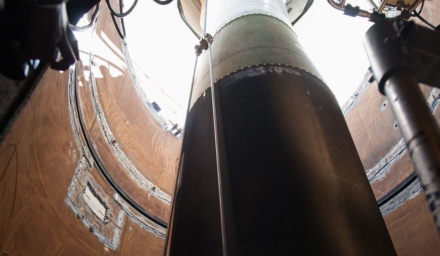 A Minuteman III booster is lowered into the tube at a launch facility in February. Air Force spokesman Ed Gulick said three options were being considered: keeping Minuteman IIIs through 2075; building a new silo-based ICBM; and deploying a mix of Minuteman IIIs and road-mobile missile. (U.S. Air Force)