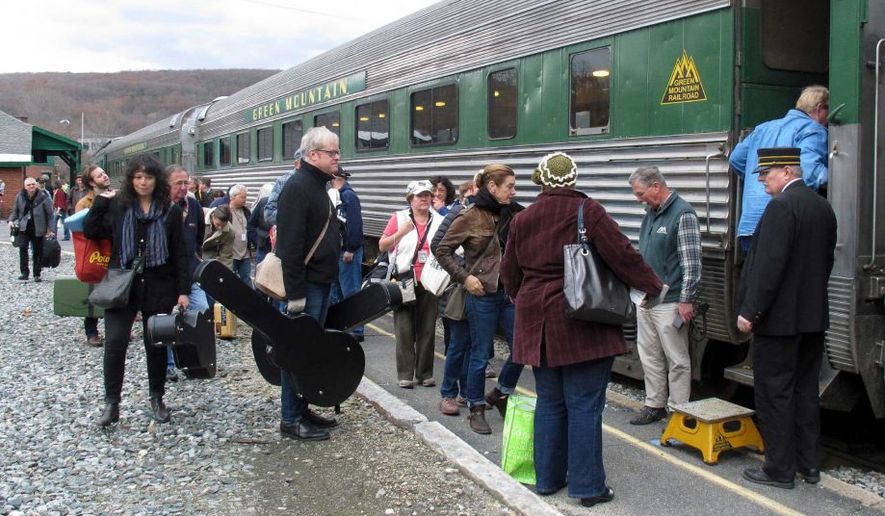 In this Saturday Nov. 7, 2015 photo, travelers board the Roots on the Rails music train in Bellows Falls, Vt. The special train made its first East Coast Trip between Bellows Falls and Rutland, Vt., where about 50 passengers spent the day listening to music while riding in vintage rail cars of the Green Mountain Railroad rolling through the countryside. (AP Photo/Wilson Ring)
