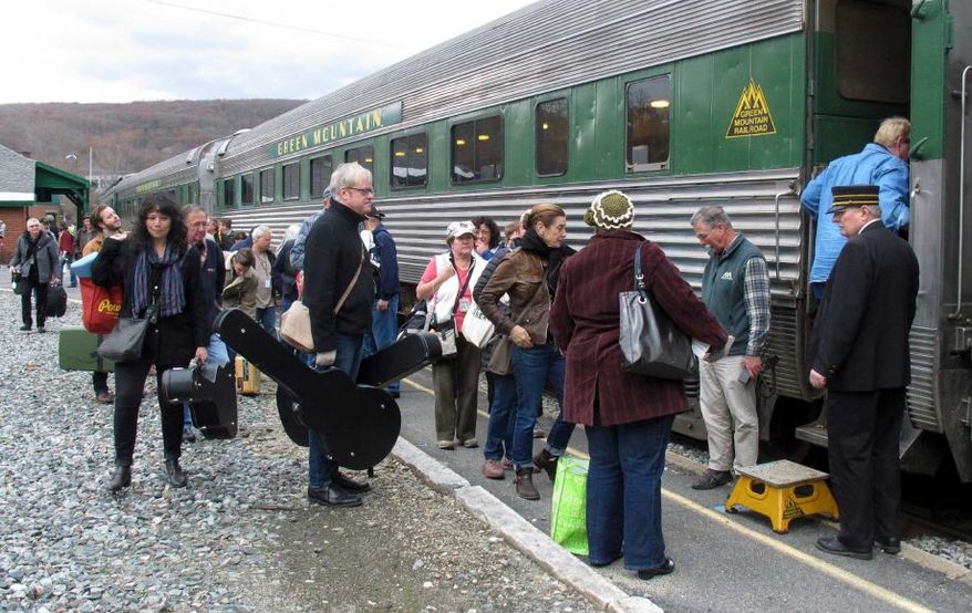 In this Saturday Nov. 7, 2015 photo, travelers board the Roots on the Rails music train in Bellows Falls, Vt. The special train made its first East Coast Trip between Bellows Falls and Rutland, Vt., where about 50 passengers spent the day listening to music while riding in vintage rail cars of the Green Mountain Railroad rolling through the countryside. (AP Photo/Wilson Ring)