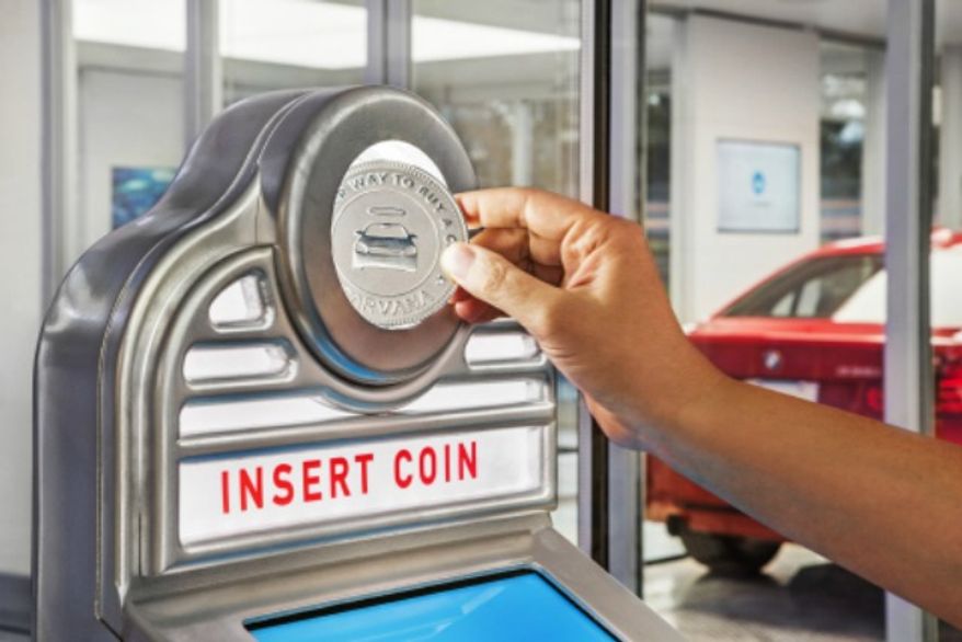 Car buyers can insert a Carvana-branded coin into the vending machine slot and deliver your car from the Tower to you in seconds. (Photo by Business Wire)