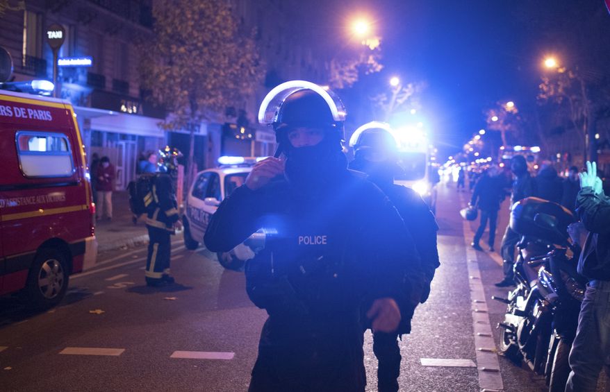 Elite police officers arrive outside the Bataclan theater in Paris, France, Wednesday, Nov. 13, 2015. Several dozen people were killed in a series of unprecedented attacks around Paris on Friday, French President Francois Hollande said, announcing that he was closing the country&#x27;s borders and declaring a state of emergency. (AP Photo/Kamil Zihnioglu)