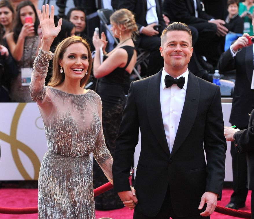In this Sunday, March 2, 2014, file photo, Angelina Jolie, left, and Brad Pitt arrive at the Oscars at the Dolby Theatre in Los Angeles. Jolie and Pitt were married Saturday, Aug. 23, 2014, in France, according to a spokesman for the couple. (Photo by Vince Bucci/Invision/AP, File) ** FILE ** 