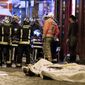 Rescue workers gather at victims in the 10th district of Paris, Friday, Nov. 13, 2015. Several dozen people were killed in a series of unprecedented attacks around Paris on Friday, French President Francois Hollande said, announcing that he was closing the country&#39;s borders and declaring a state of emergency. (AP Photo/Jacques Brinon)