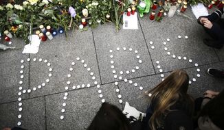 Young women have formed  the word Paris with candles to mourn for the victims killed in  Friday&#39;s attacks in Paris, France, in front of the French Embassy in Berlin, Saturday, Nov. 14, 2015. French President Francois Hollande said more than 120 people died Friday night in shootings at Paris cafes, suicide bombings near France&#39;s national stadium and a hostage-taking slaughter inside a concert hall.  (AP Photo/Markus Schreiber)