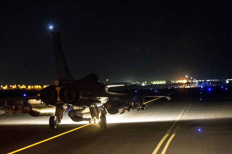 France launched massive airstrikes on the Islamic State group's de-facto capital in Syria on Sunday night, destroying a jihadi training camp and a munitions dump in the city of Raqqa, where Iraqi intelligence officials say the attacks on Paris were planned. (Associated Press)