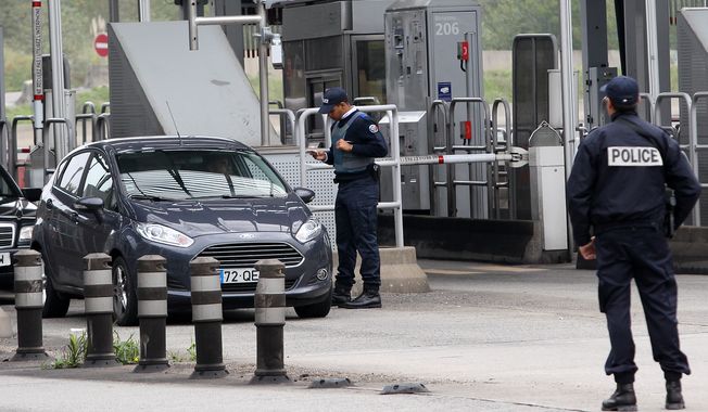 French police officers check vehicles leaving France at the border crossing between France and Spain in Biriatou on Saturday, Nov. 14, 2015. (Associated Press)
