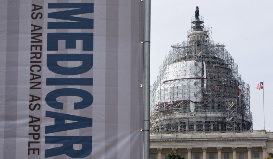 In this July 30, 2015, file photo, a sign supporting Medicare is seen on Capitol Hill in Washington as registered nurses and other community leaders celebrate the 50th anniversary of Medicare and Medicaid. (AP Photo/Jacquelyn Martin, File)