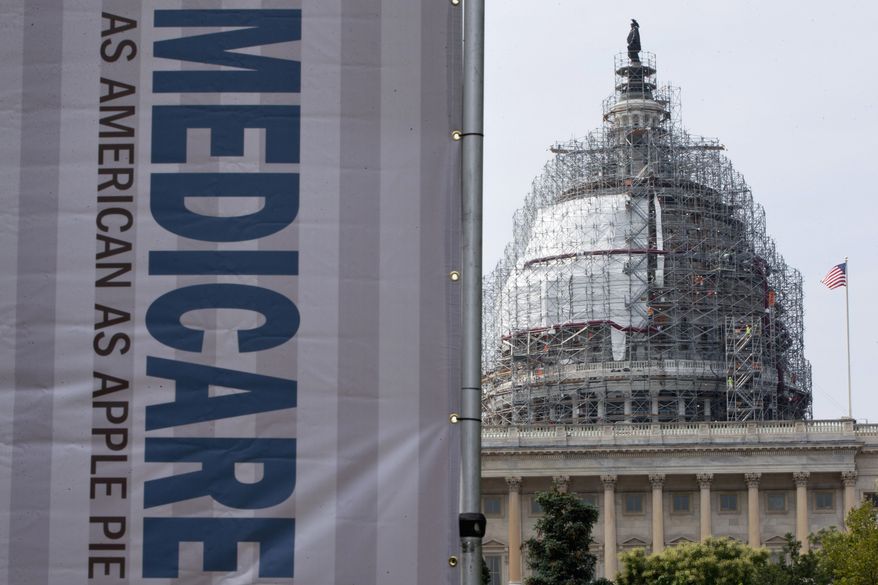 In this July 30, 2015, file photo, a sign supporting Medicare is seen on Capitol Hill in Washington as registered nurses and other community leaders celebrate the 50th anniversary of Medicare and Medicaid. (AP Photo/Jacquelyn Martin, File)
