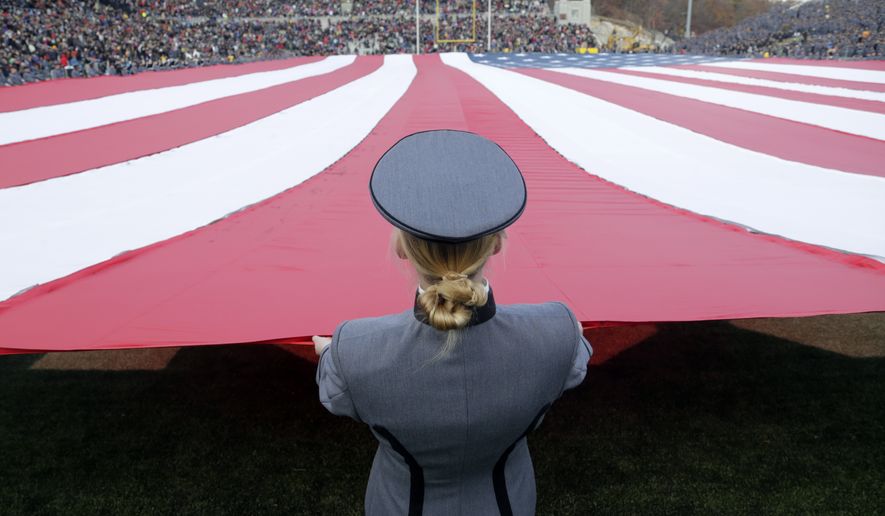 Cadets hold an American flag on the field during halftime on Military Appreciation Day during an NCAA college football game between Army and Tulane on Saturday, Nov. 14, 2015, in West Point, N.Y. Tulane won 34-31. (AP Photo/Mike Groll)