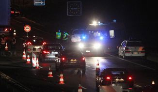 French police check vehicles at the border crossing between France and Belgium as part of the hunt for fugitives in the Paris attacks. (Associated Press)