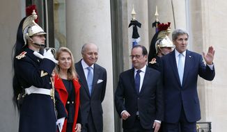 U.S. Secretary of State John Kerry, right, poses with French President Francois Hollande, second right, and U.S. Ambassador to France Jane D. Hartley, left, with French Foreign Laurent Fabius upon arrival at the Elysee Palace, in Paris, France, Tuesday, Nov. 17, 2015. Kerry arrived in Paris to pay tribute to last Friday November 13 attacks in France. (AP Photo/Francois Mori)