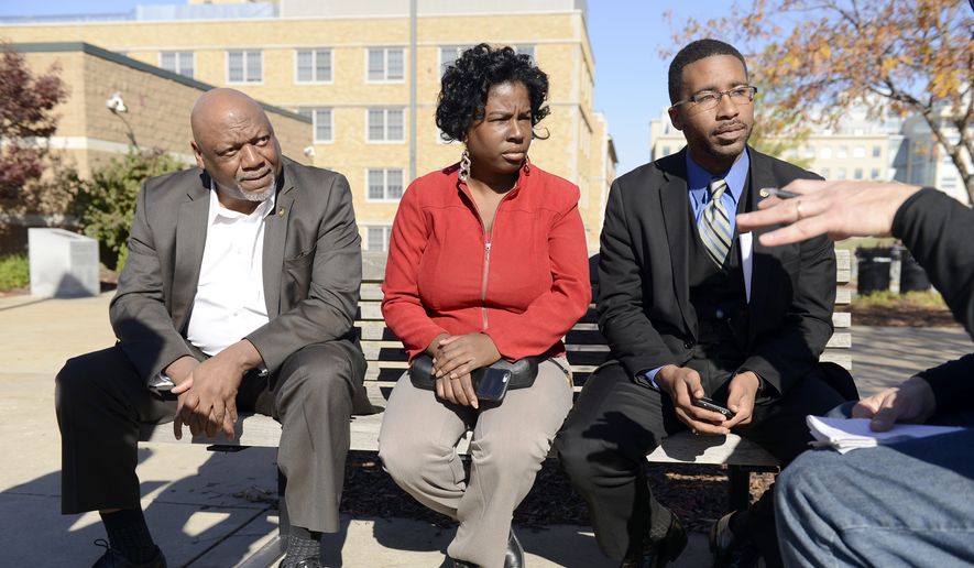 State Reps.Tommie Pierson, left, Karla May, center and Brandon Ellington, right, of the Missouri Legislative Black Caucus talk to Associated Press reporter Alan Zagier outside the Gaines/Oldham Black Culture Center, Tuesday, Nov. 10, 2015, on the University of Missouri campus in Columbia, Mo. They were there to talk to students and faculty about issues on campus. The meetings were closed to media. (Justin L. Stewart/Missourian via AP) ** FILE **