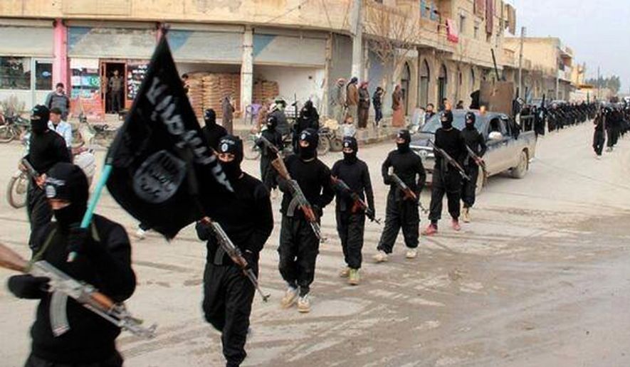 This undated file image posted on a militant website on Jan. 14, 2014, which has been verified and is consistent with other AP reporting, shows fighters from the al Qaeda-linked Islamic State of Iraq and the Levant (ISIL) marching in Raqqa, Syria. (AP Photo/Militant Website, File)