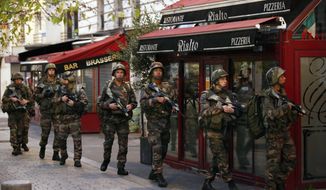 Soldiers operate in St. Denis, a northern suburb of Paris, Wednesday, Nov. 18, 2015. Authorities in the Paris suburb of St. Denis are telling residents to stay inside during a large police operation near France&#39;s national stadium that two officials say is linked to last week&#39;s deadly attacks. (AP Photo/Francois Mori)

